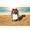Golden Sands Potpourri bag on a beach with the sun shimmering on ocean waves in the background, capturing a classic, masculine fragrance.